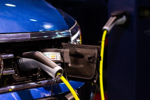 Charging an electric or hybrid PHEV car with the power cable supply plugged in