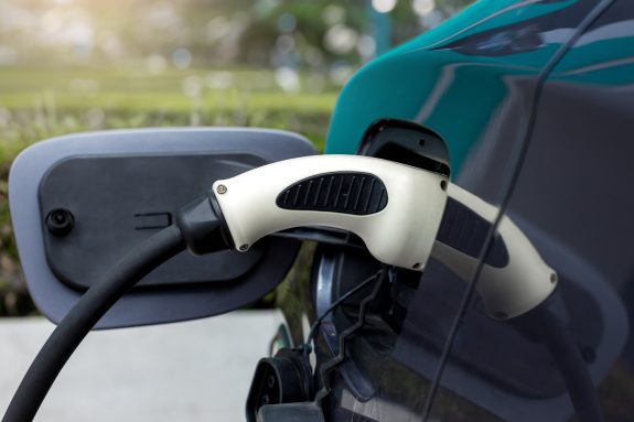 Electric car charging on parking and charging station. Electric socket. Transportation EV.