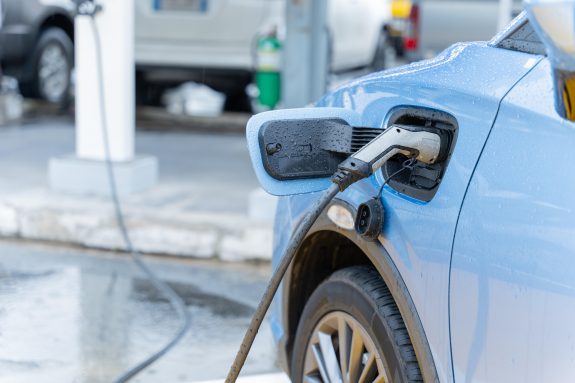 Electric car on electric car charging station. Power supply for electric car charging. Clean energy concept.